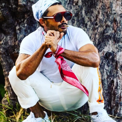 People at a concert facing the stage with various colours of paint powder in the air